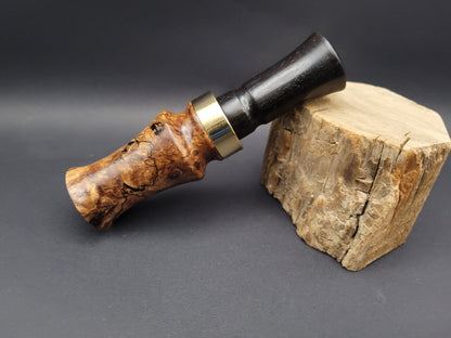 A traditional style j-frame duck call made of African blackwood with maple burl